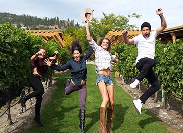 Jumping in Vineyards Kelowna Wine Tours | Cheers! Okanagan Tours
