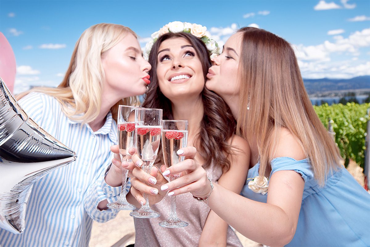 Kiss the Bride Three young women celebrating in a winery