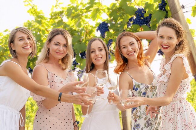Women at a bachelorette party in a winery orchard