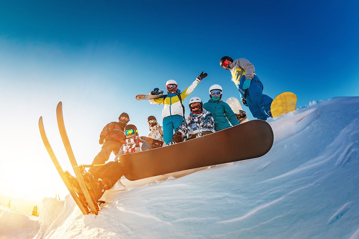 Big group of skiers and snowboarders Big group of happy skiers and snowboarders are posing against blue sky